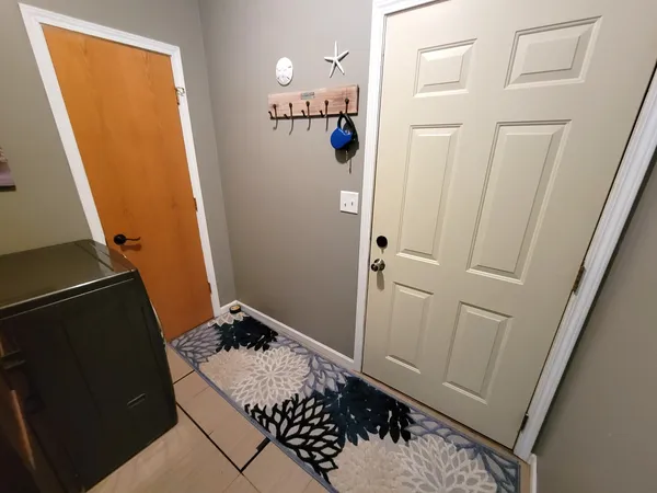 a backyard of a house with barbeque oven and table