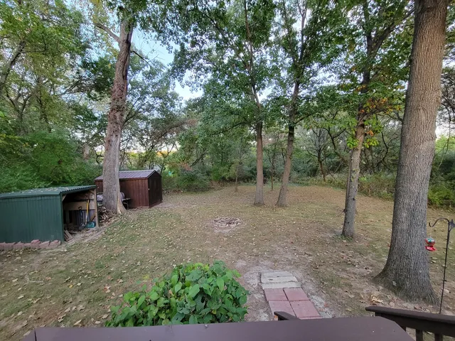 a roof deck with table and chairs and wooden floor
