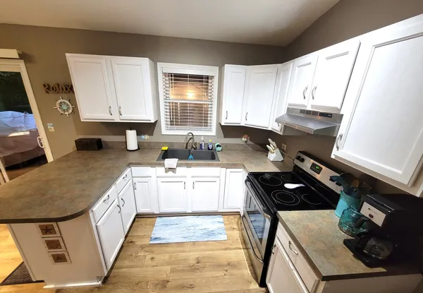 a kitchen with a stove a sink and a refrigerator