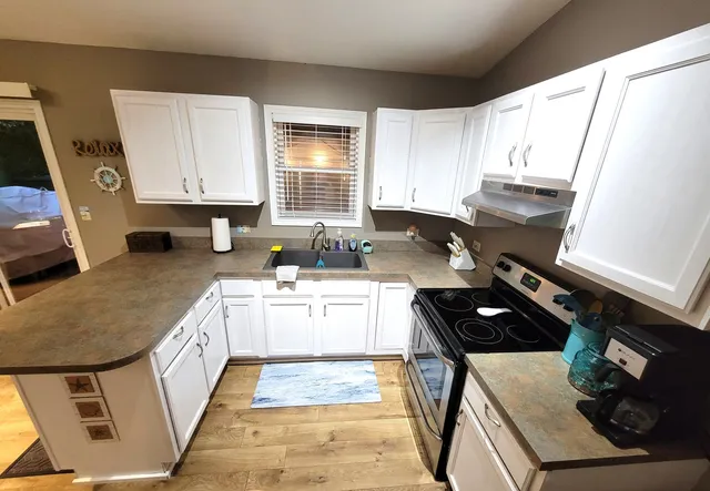 a kitchen with a stove a sink and a refrigerator