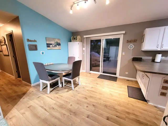 a view of a dining room with furniture and a chandelier