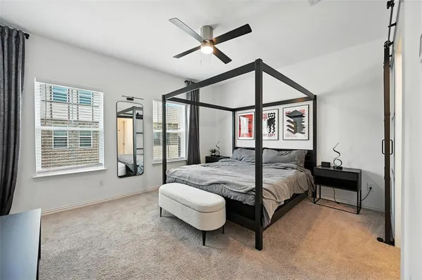 a spacious bedroom with a bed and a large window