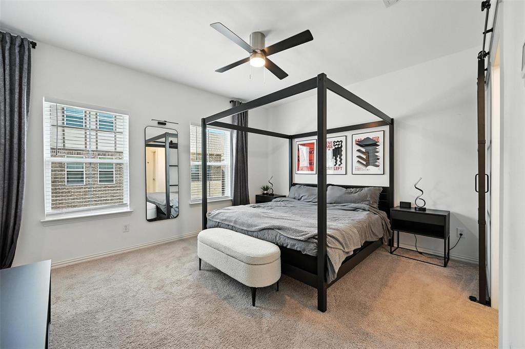 7513 Laburnam Road Dallas, TX 75228 - Photo 14 of 23 a spacious bedroom with a bed and a large window
