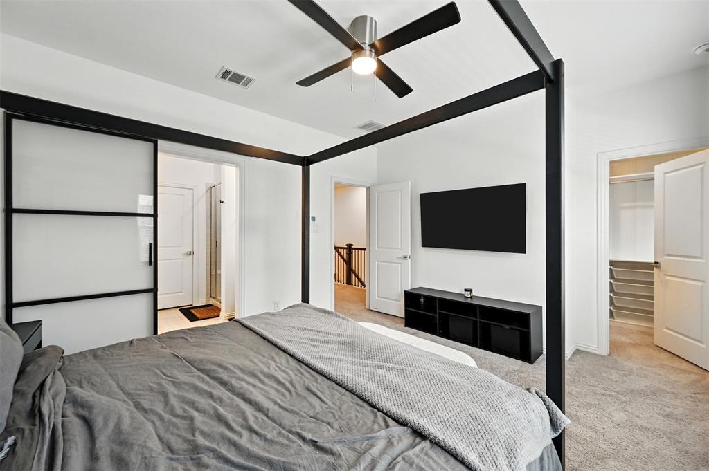 7513 Laburnam Road Dallas, TX 75228 - Photo 15 of 23 a bedroom with a bed and a flat tv screen