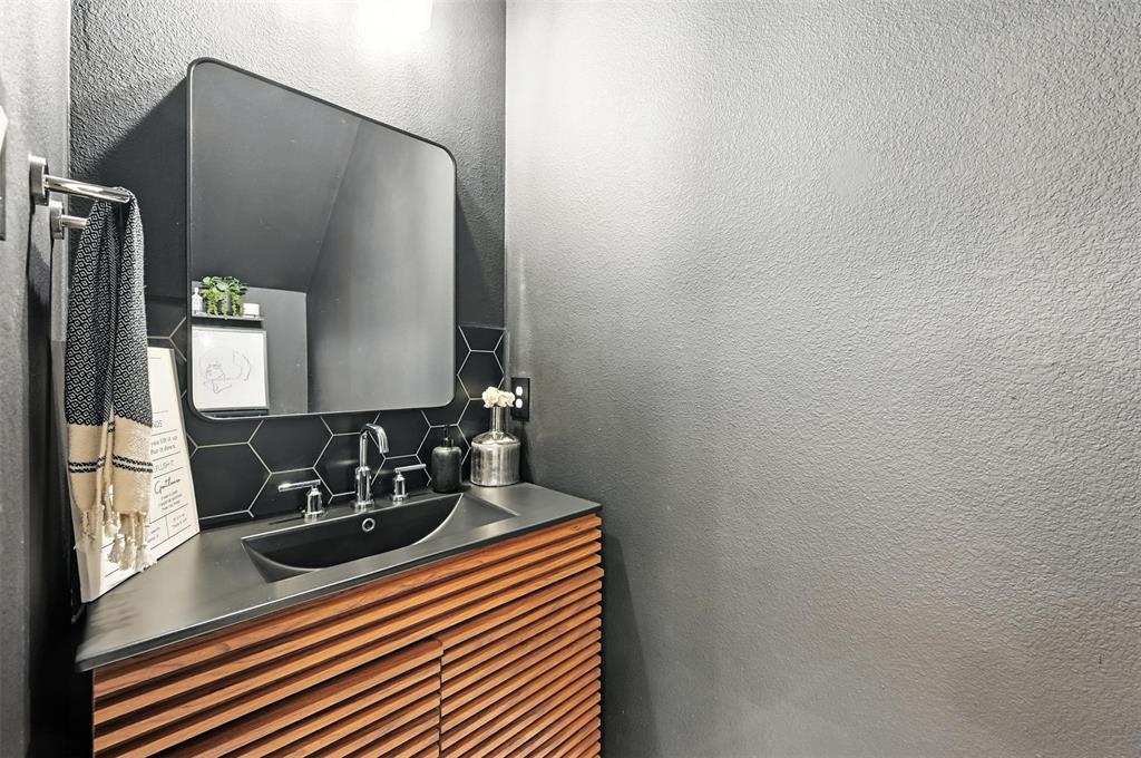 7513 Laburnam Road Dallas, TX 75228 - Photo 2 of 23 a bathroom with a sink and a mirror