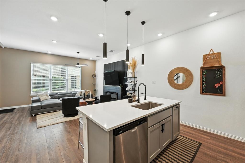 7513 Laburnam Road Dallas, TX 75228 - Photo 8 of 23 a kitchen with a wooden floor and a view of living room