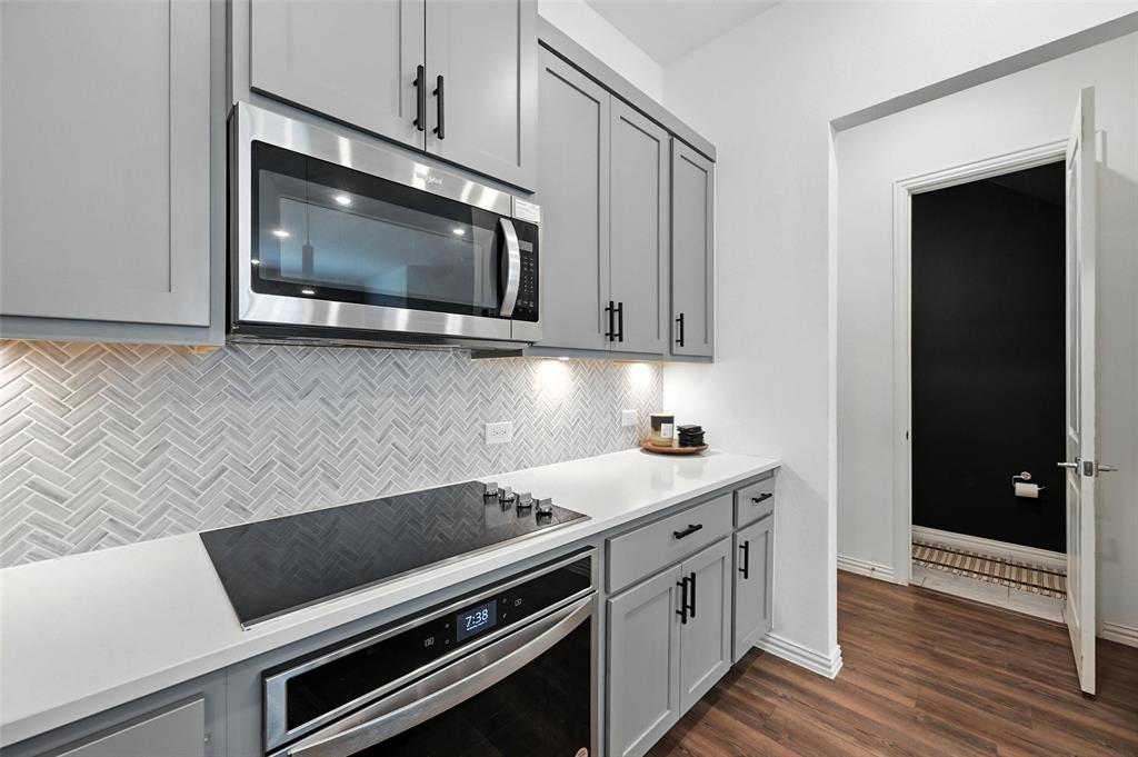 7513 Laburnam Road Dallas, TX 75228 - Photo 9 of 23 a kitchen with a stove and a microwave