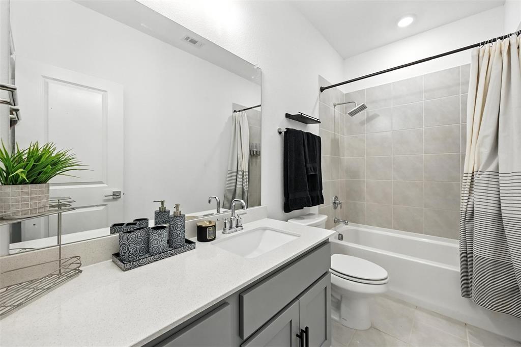 7513 Laburnam Road Dallas, TX 75228 - Photo 10 of 23 a bathroom with a sink a toilet a tub and shower