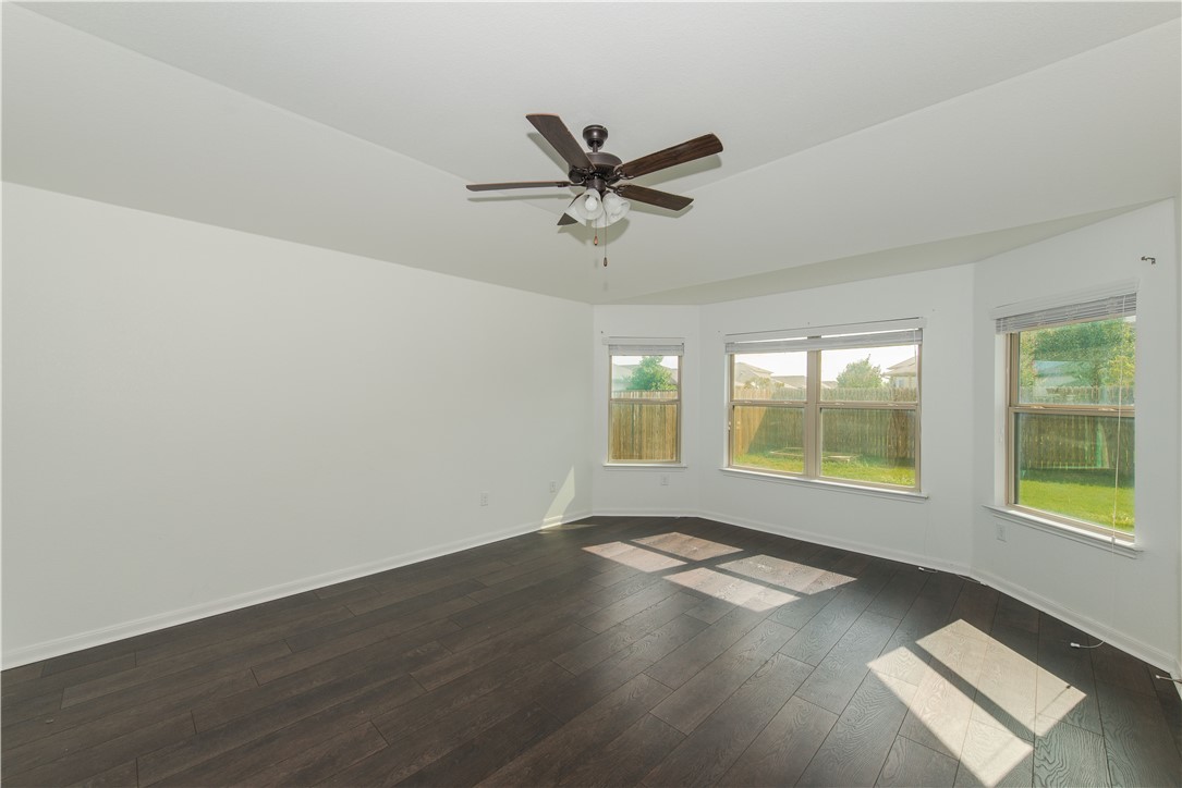 1007 Plateau Trail Georgetown, TX 78626 - Photo 11 of 32 wooden floor in an empty room with a window