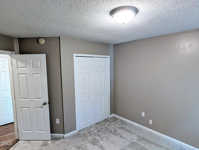 an empty room with closet area