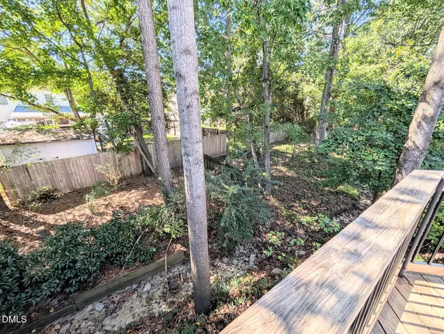a view of a house with a tree in the background