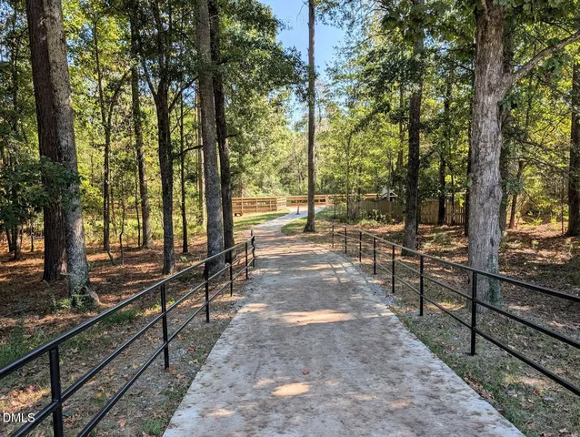a view of balcony with wooden floor and fence