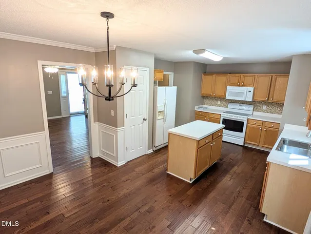 a kitchen with stainless steel appliances a stove top oven and cabinets