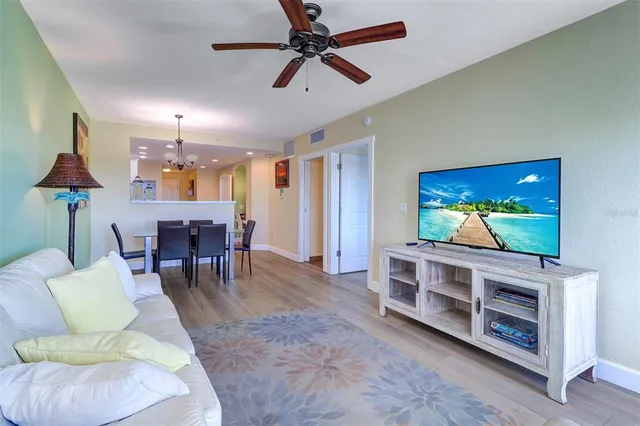 a view of a dining room with furniture wooden floor and chandelier