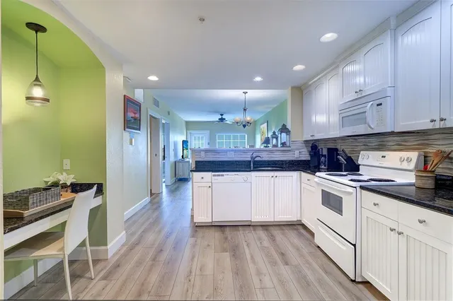 a kitchen with stainless steel appliances granite countertop a stove and a refrigerator