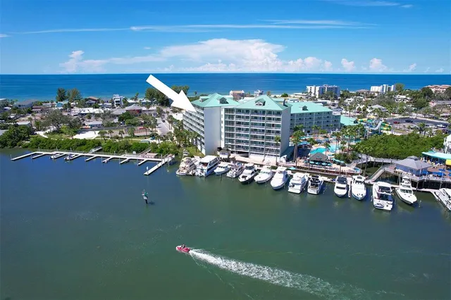 a front view of a house with garden and trees