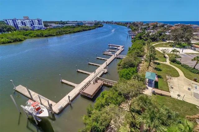 a store with outdoor seating area and potted plants