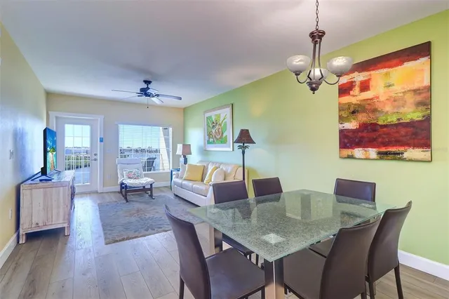 a living room with furniture a flat screen tv and a window