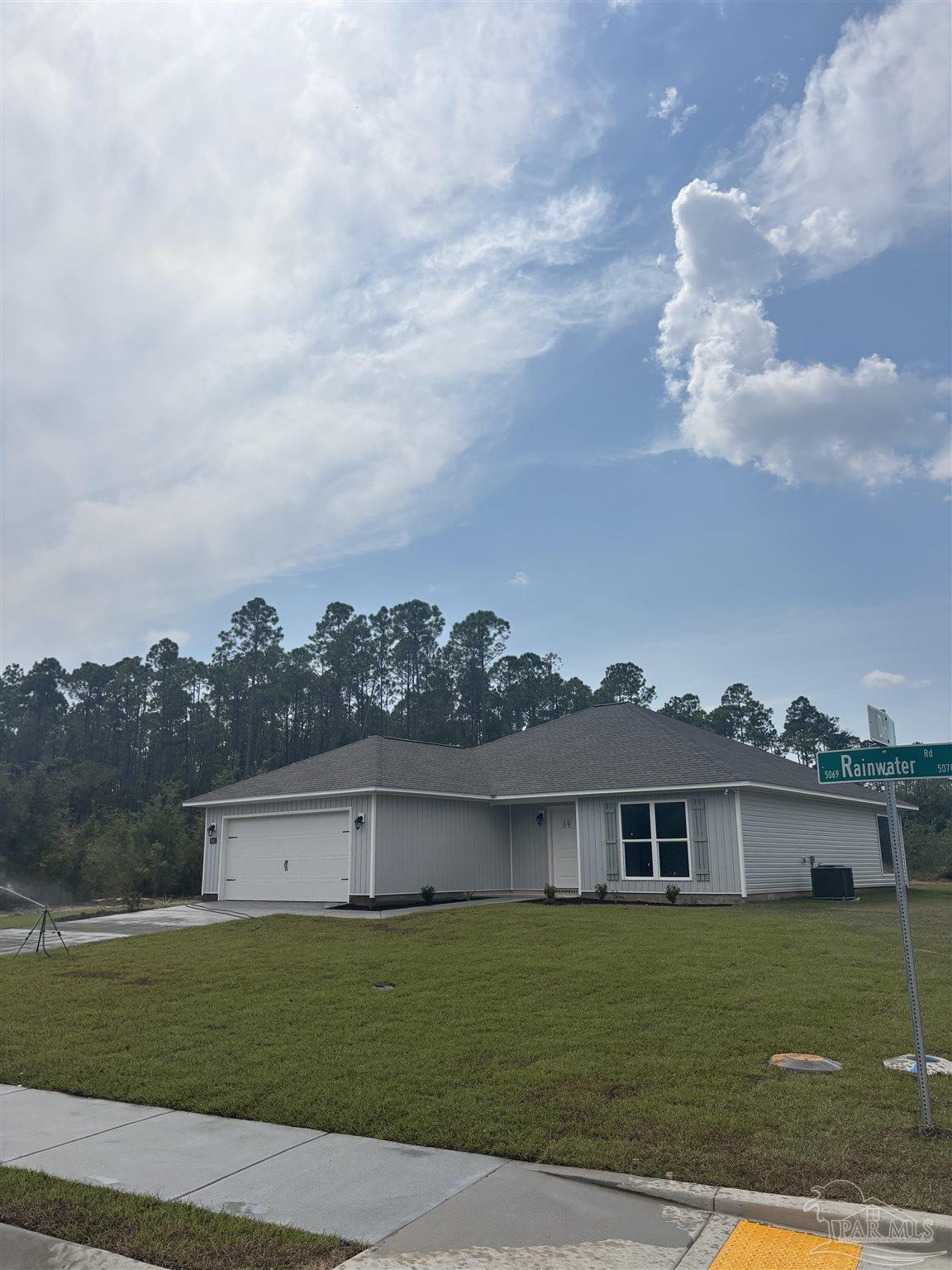 5063 Rainwater Road Milton, FL 32583 - Photo 2 of 22 front view of a house with a yard