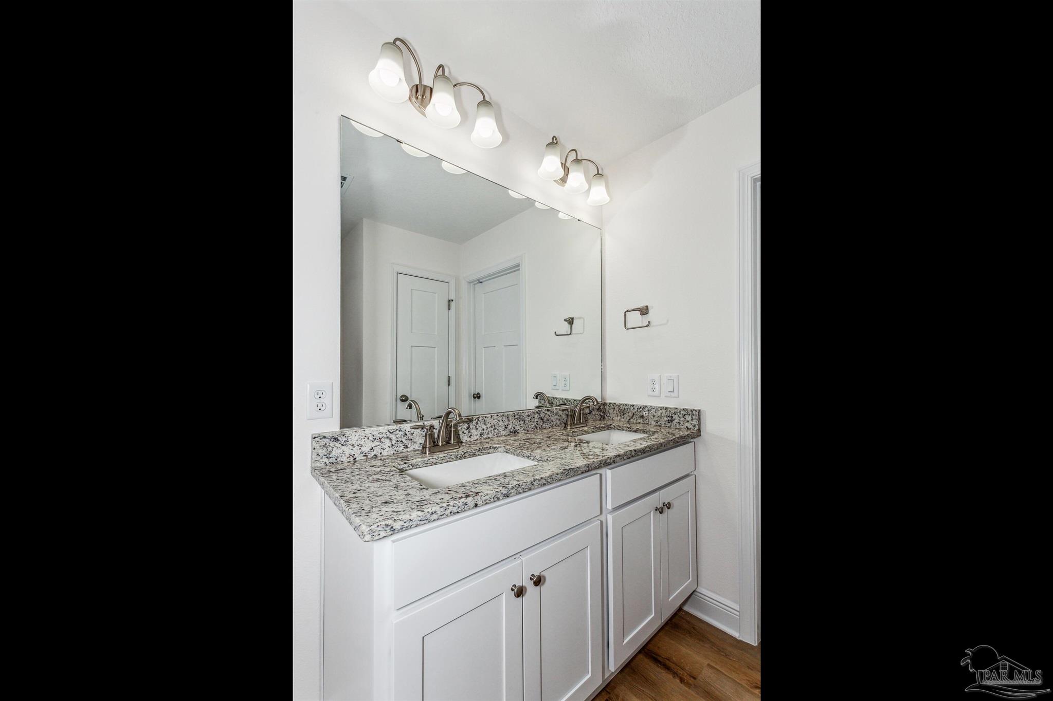 5063 Rainwater Road Milton, FL 32583 - Photo 21 of 22 a bathroom with a granite countertop double vanity sink and a mirror