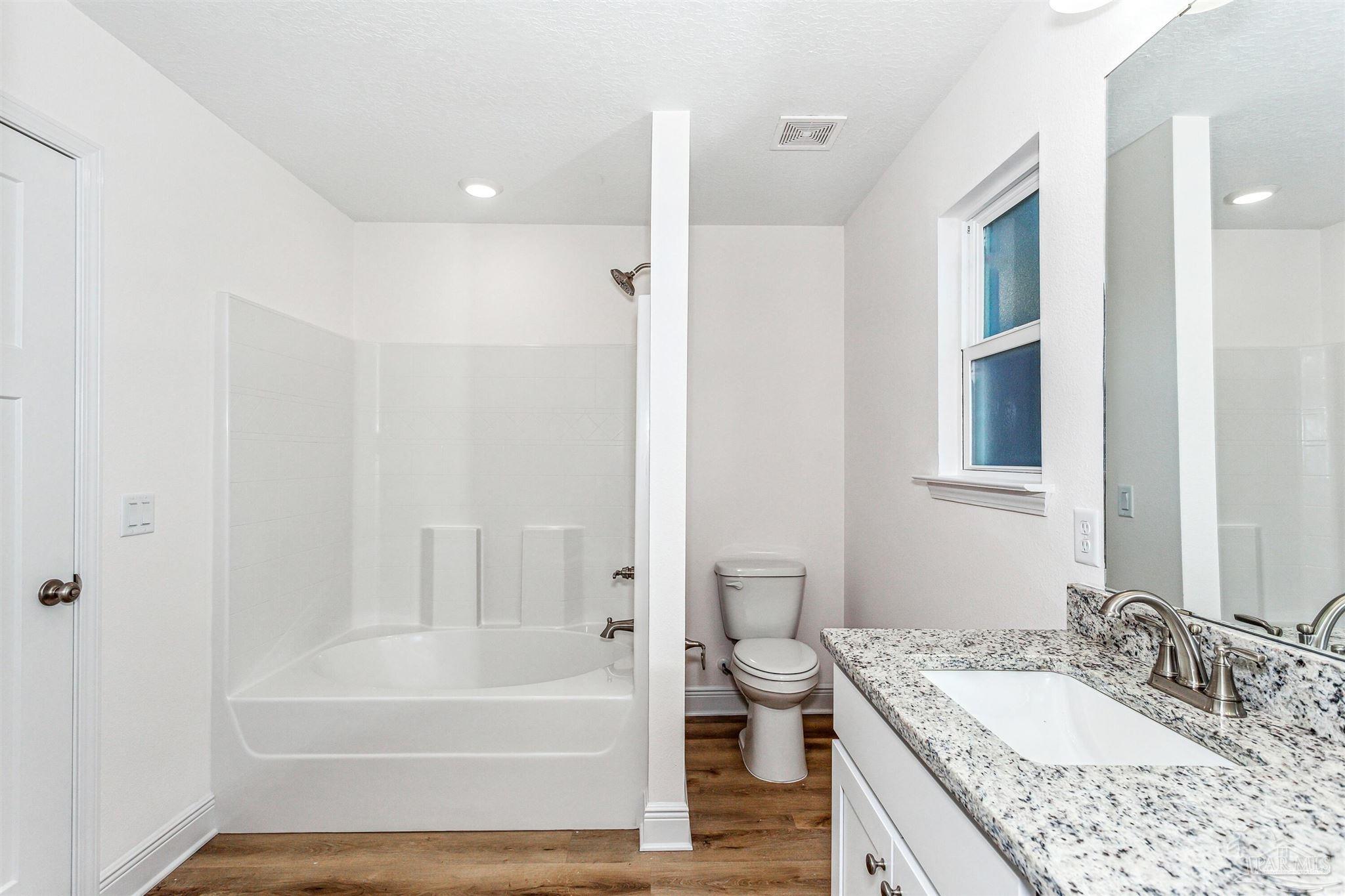 5063 Rainwater Road Milton, FL 32583 - Photo 22 of 22 a bathroom with a granite countertop sink and a mirror