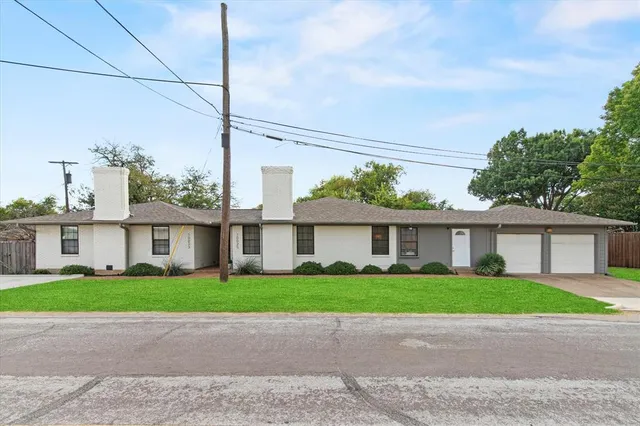 a front view of a house with a garden and plants