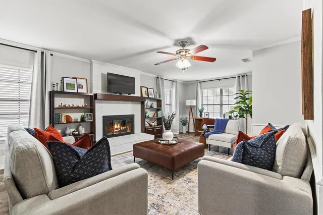 a living room with furniture a flat screen tv and a fireplace