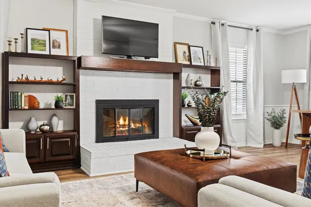 a living room with furniture a flat screen tv and a fireplace