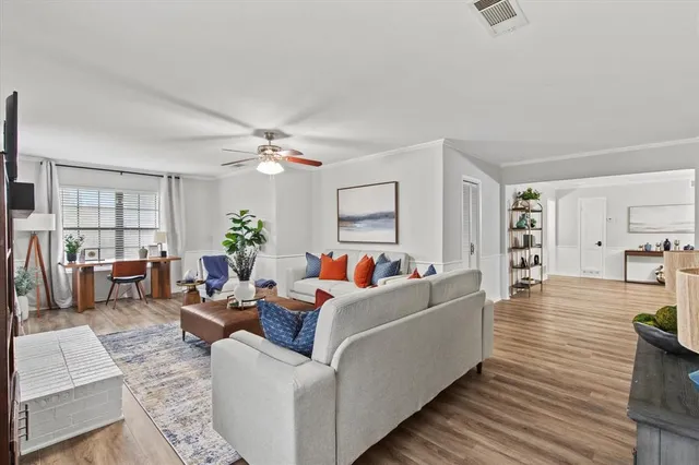 a living room with furniture and wooden floor