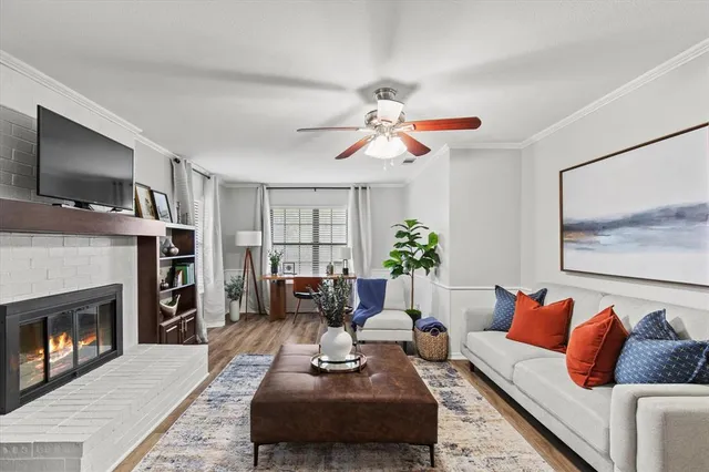a living room with furniture a flat screen tv and a fireplace