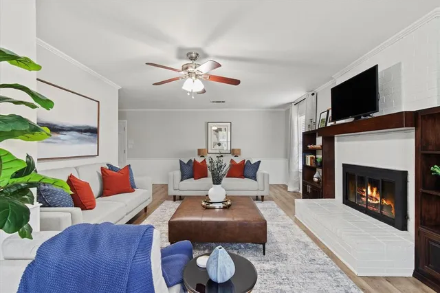 a living room with furniture fireplace and flat screen tv