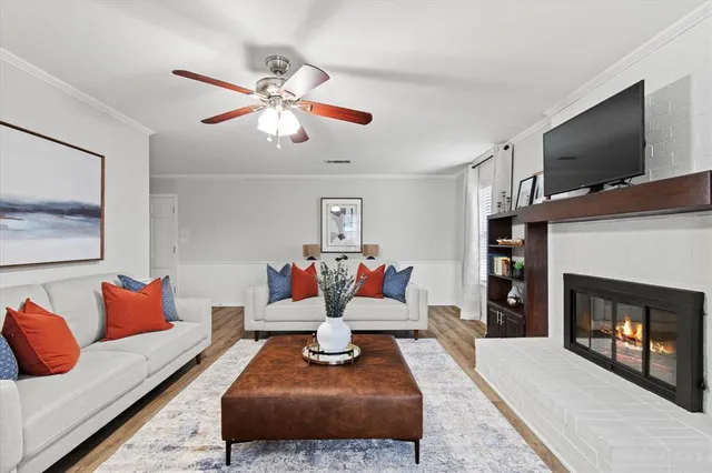 a living room with furniture fireplace and flat screen tv