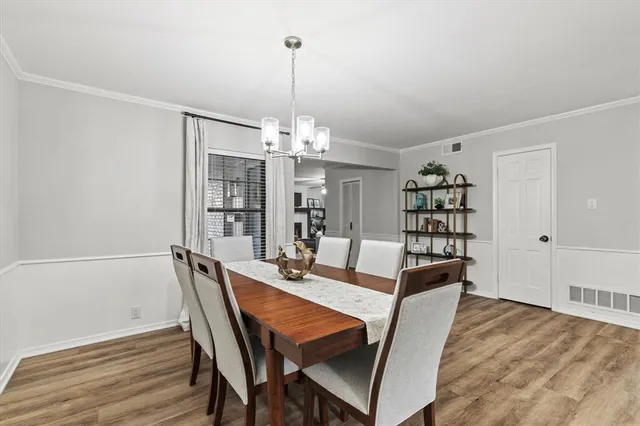 a view of a dining room with furniture wooden floor and chandelier