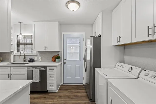 a view of a kitchen with refrigerator and sink