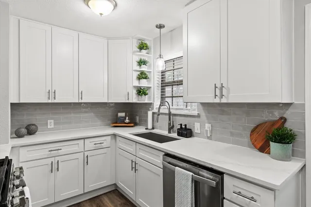a kitchen with stainless steel appliances white cabinets and a sink