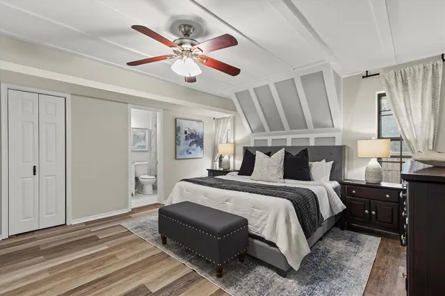 a bedroom with bed and wooden floor