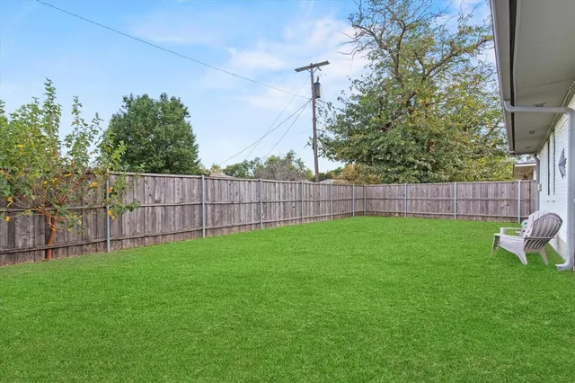 a garden with trees in the background