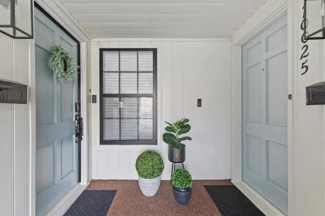 a view of front door and wooden floor