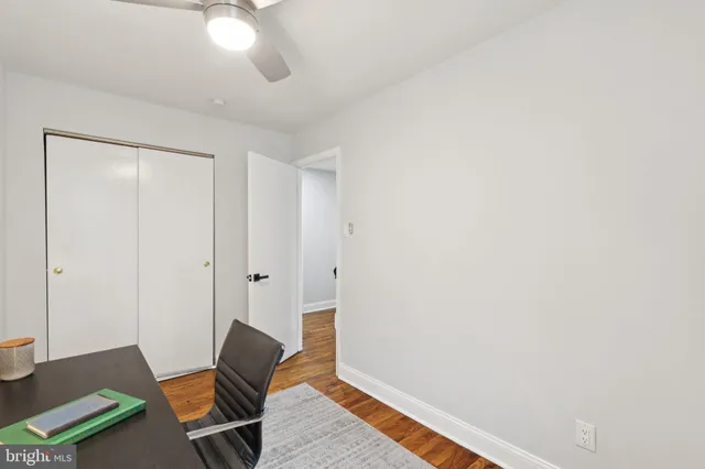 a view of a livingroom with chair and wooden floor