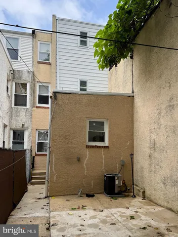 a side view of a house with a potted plant