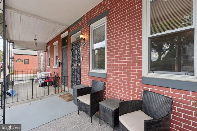a brick building with a bench in front of it
