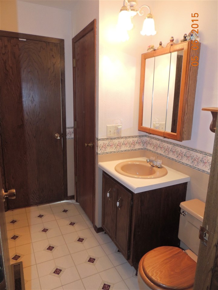 16349 Best Road Davis, IL 61019 - Photo 15 of 25 a bathroom with a sink a toilet and mirror