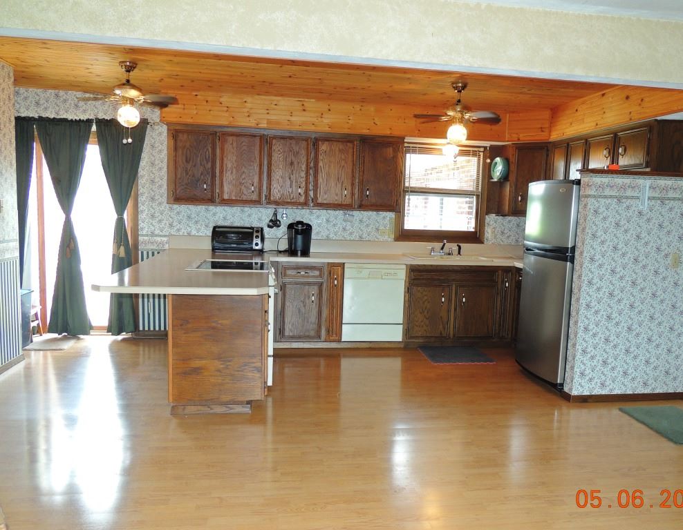 16349 Best Road Davis, IL 61019 - Photo 6 of 25 a kitchen with stainless steel appliances granite countertop a refrigerator a sink dishwasher a stove with wooden cabinets and floor