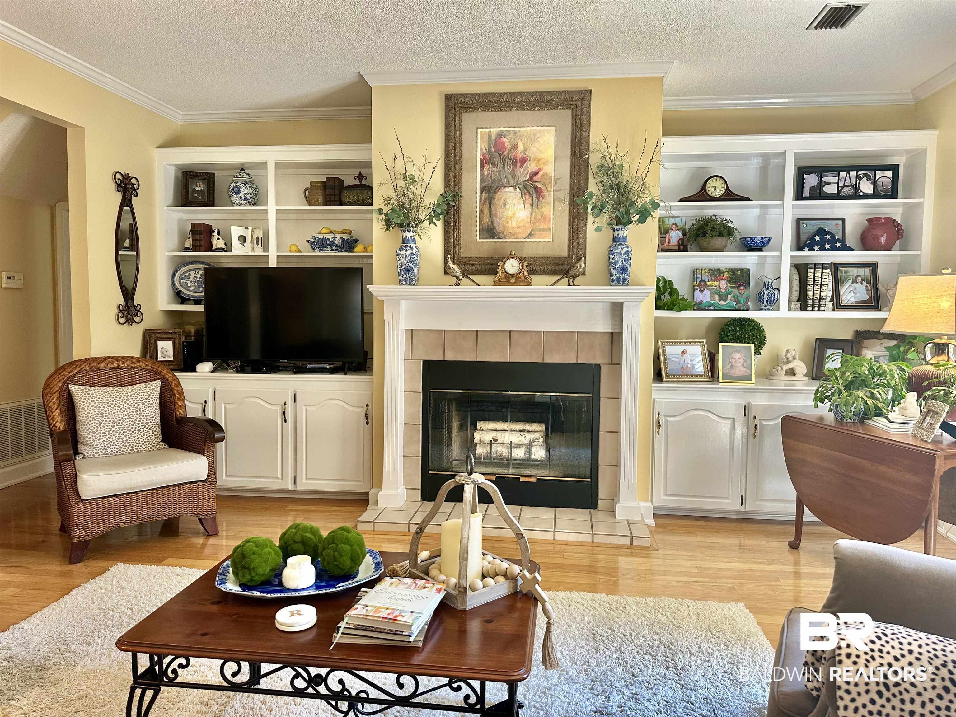 148 Brooks Boulevard Brewton, AL 36426 - Photo 8 of 45 Living room with visible vents, light wood-style floors, crown molding, and a textured ceiling
