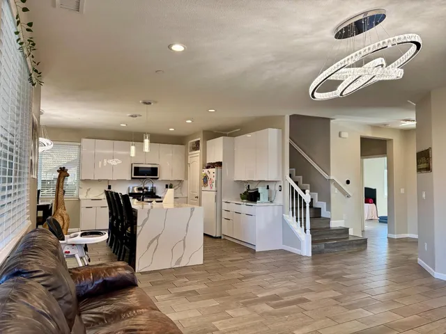 a view of a living room and a kitchen with furniture
