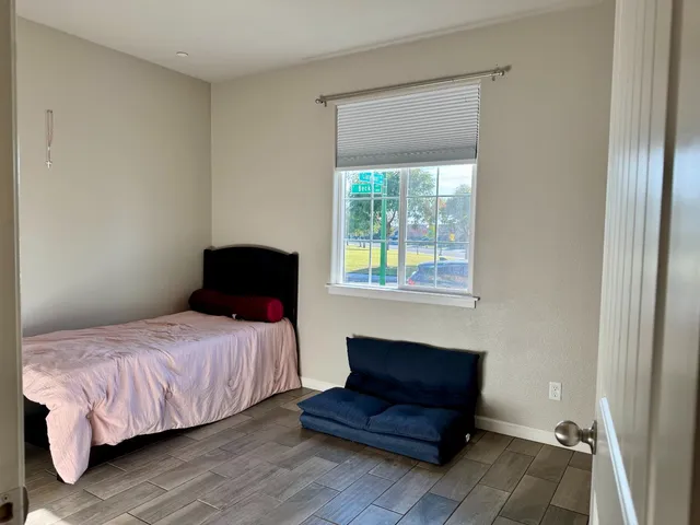 a bedroom with a bed and a window