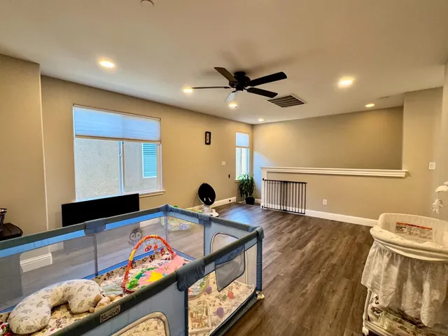 a living room with furniture flat screen tv and a large window