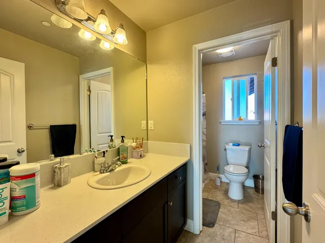 a bathroom with a double vanity sink and a mirror