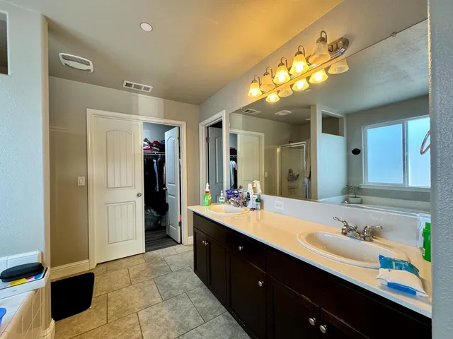 a bathroom with a sink vanity and a mirror