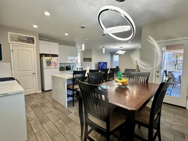 a view of a dining room with furniture and a chandelier